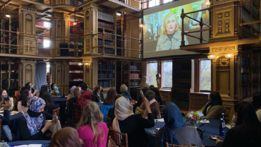 Photo of former Secretary of State Hillary Rodham Clinton on screen in a video message to evacuated Afghan women leaders in April 2022.