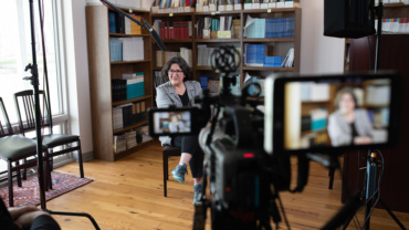 Photo of Yalda Royan being interviewed on a video camera