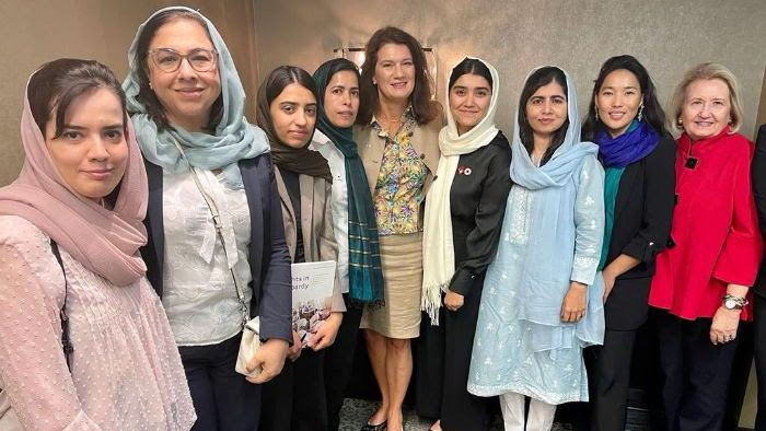 Malala Yousafzi standing with a group of women from the Georgetown Institute for Women, Peace, and Security